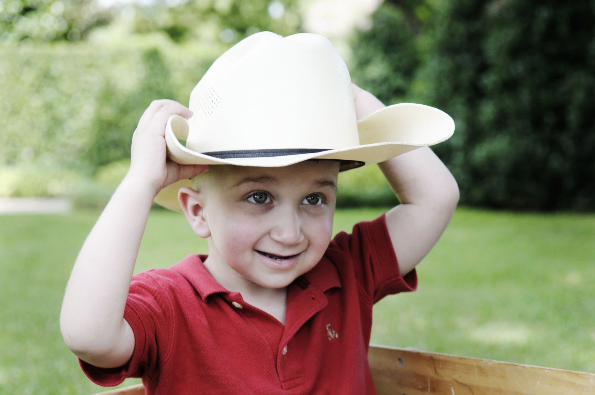 Ryan Goldblatt wearing cowboy hat and red polo shirt.