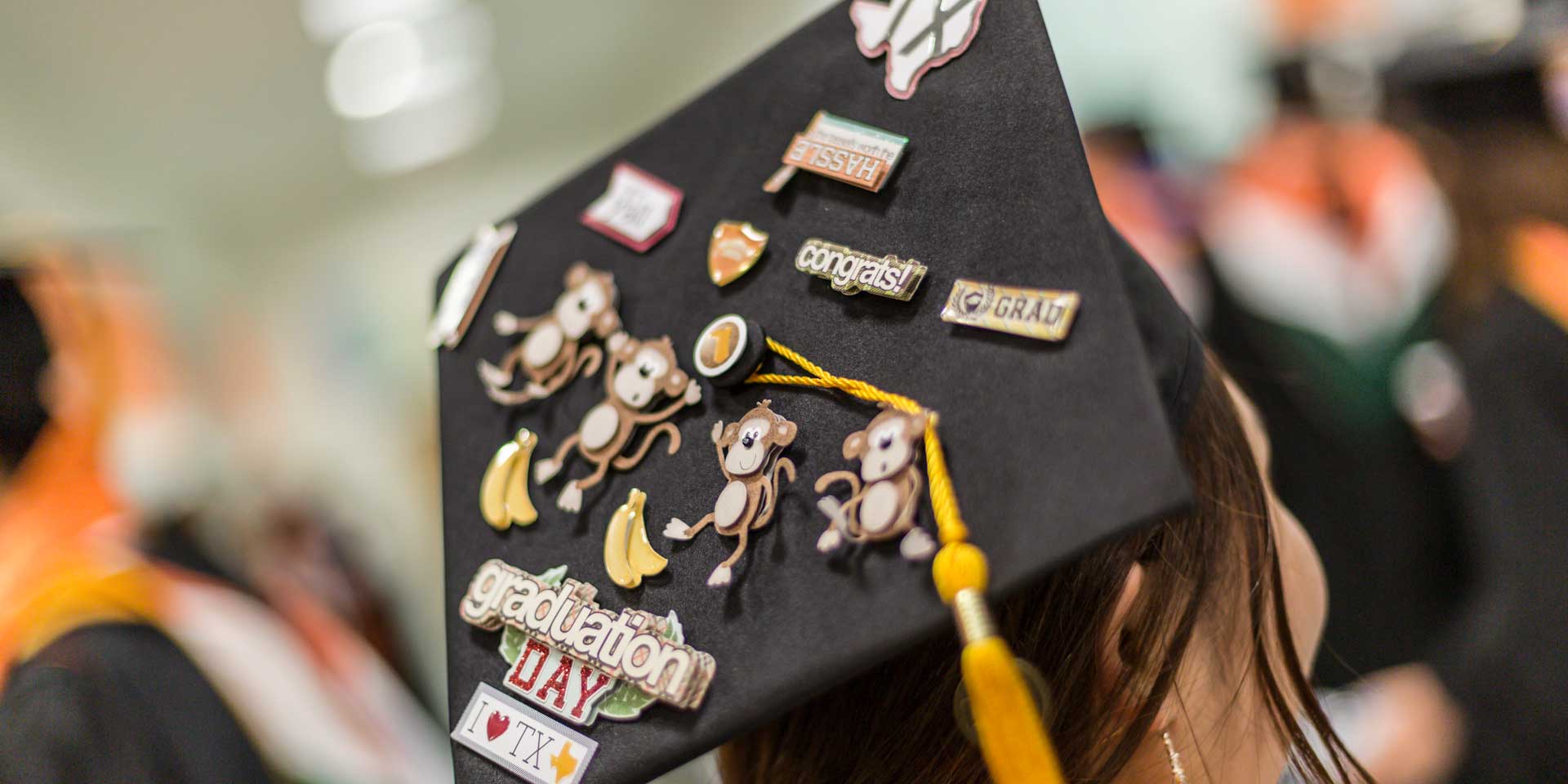 She earned a master's degree in finance and personalized her mortarboard with characters representing her birth during the Year of the Monkey and with Texas-themed decorations.
